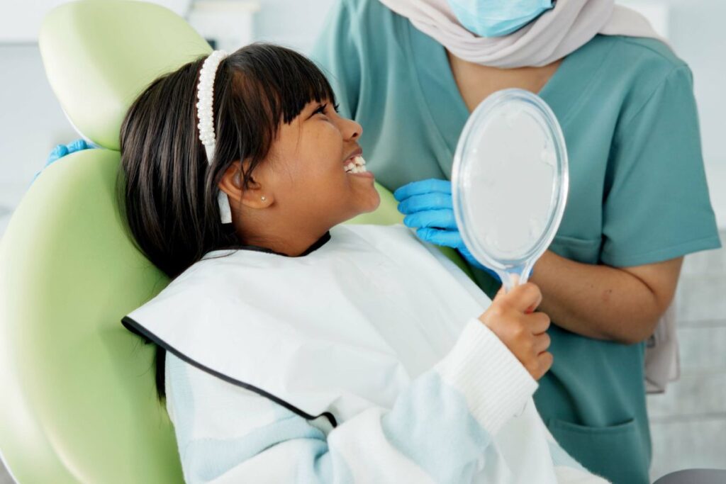Our Pediatric dentist in Hawthorn Woods checking a kids teeth